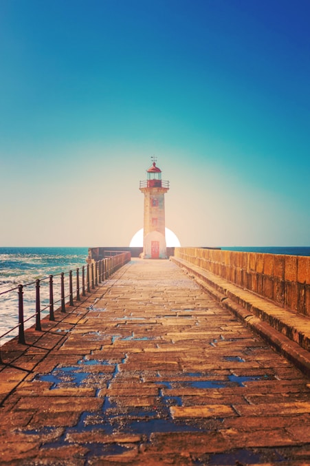 white and black lighthouse on dock during daytime
