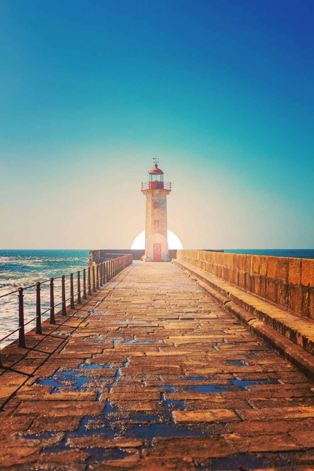 white and black lighthouse on dock during daytime