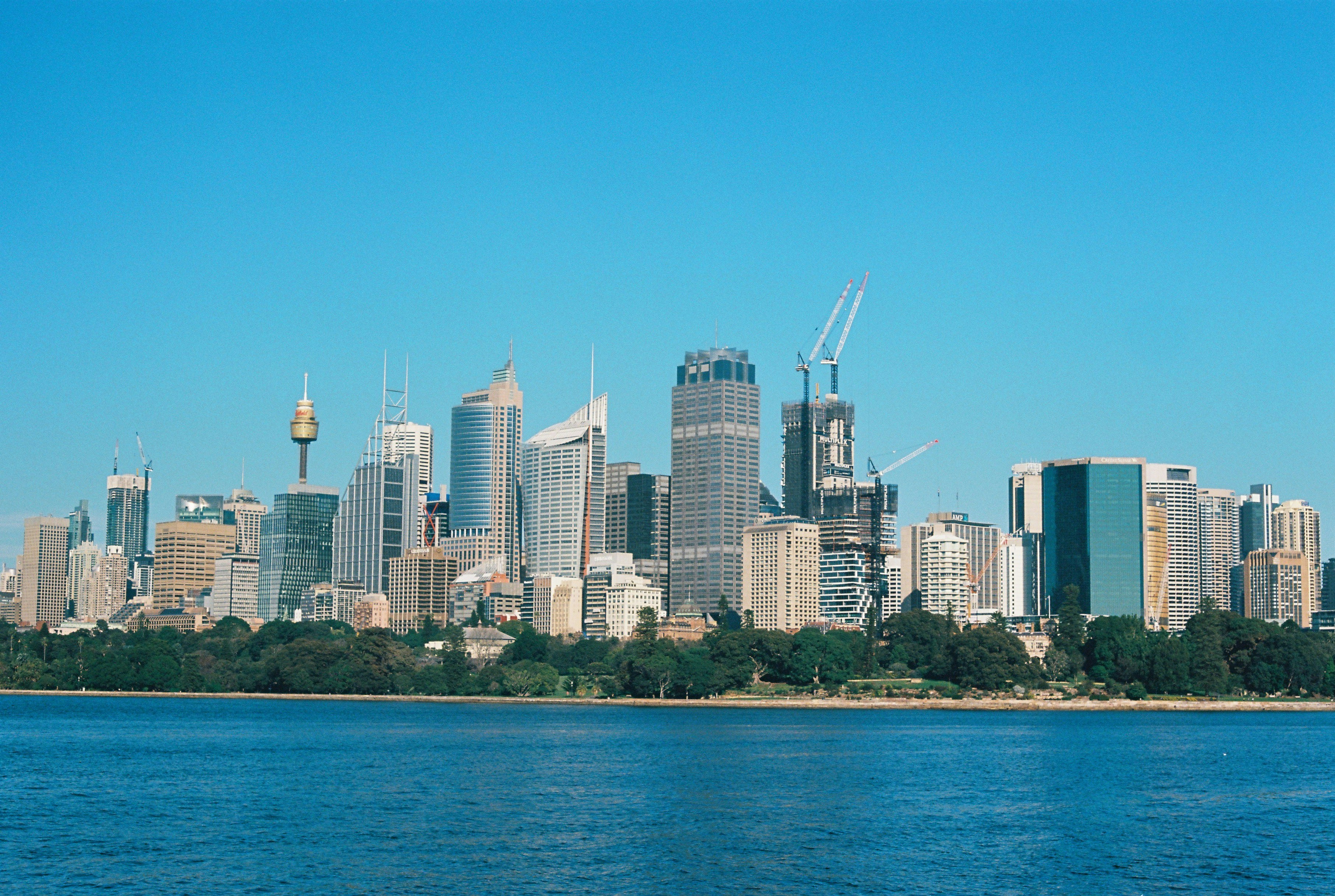 city skyline across body of water during daytime