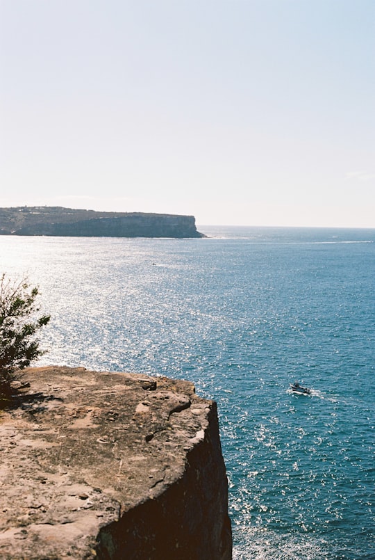 brown rocky mountain beside blue sea during daytime in Watsons Bay NSW Australia