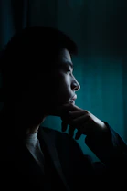woman in black blazer looking at her left side