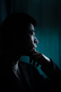 woman in black blazer looking at her left side