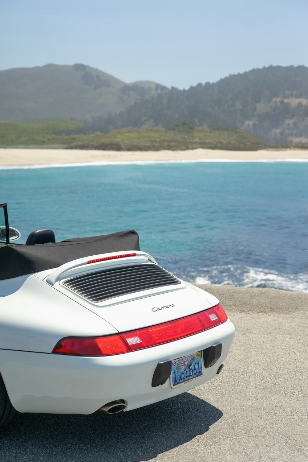 white and red chevrolet camaro on beach shore during daytime