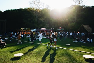 A vibrant community gathering in a lush green outdoor setting, showcasing local culture and sustainable practices.