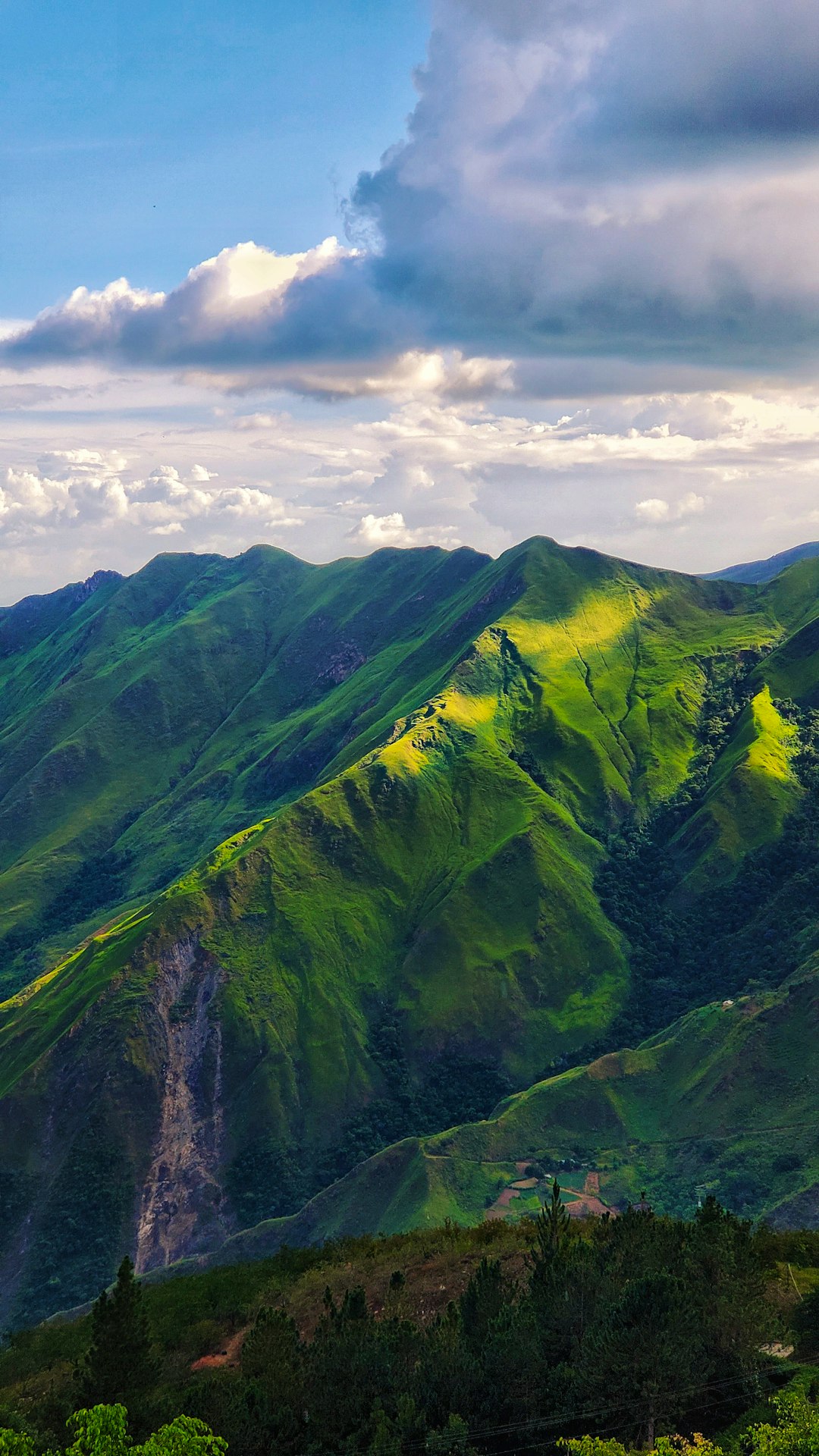 green mountain under white clouds during daytime