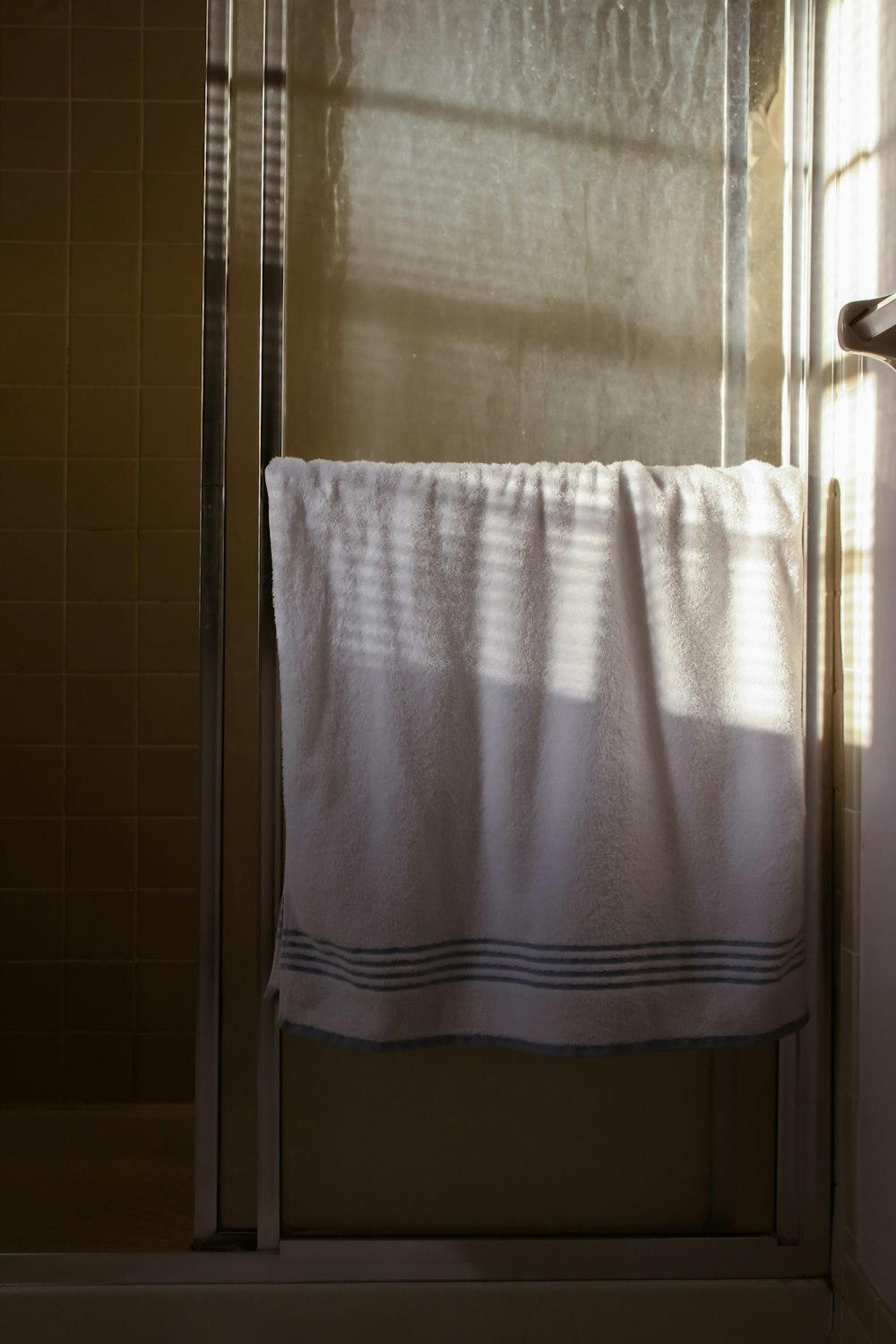 white towel on stainless steel towel bar