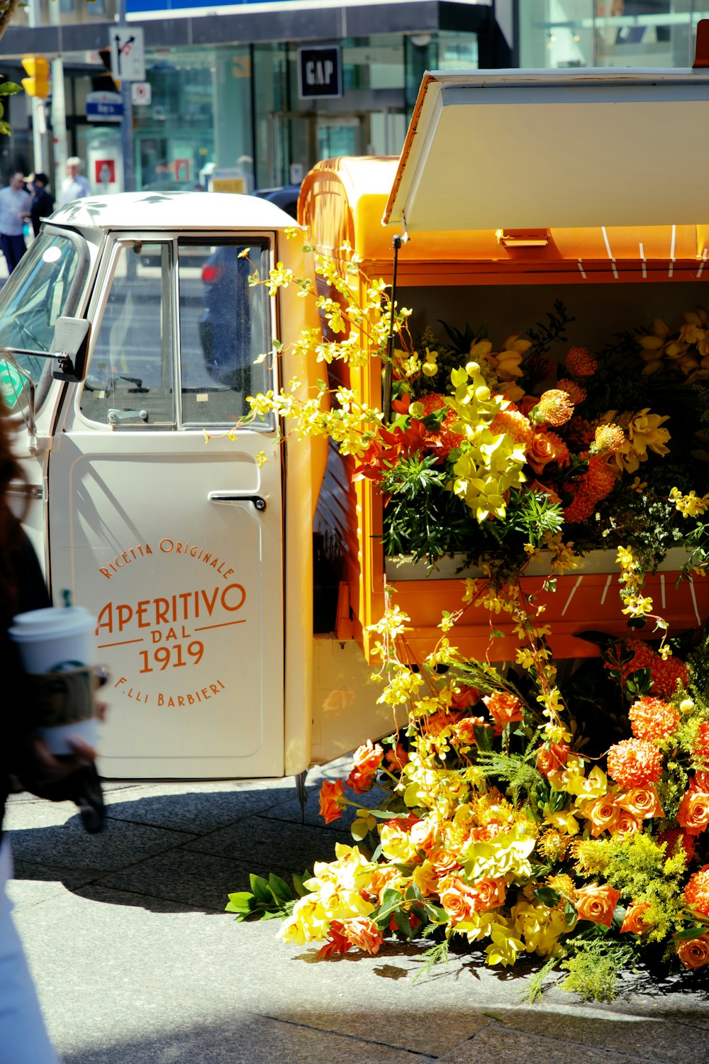 yellow and red flowers on white and red van