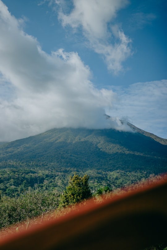 green mountain under white clouds during daytime in Canlaon Volcano Philippines