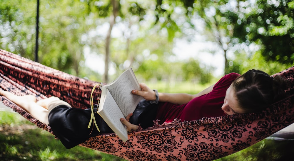 person in red long sleeve shirt reading book