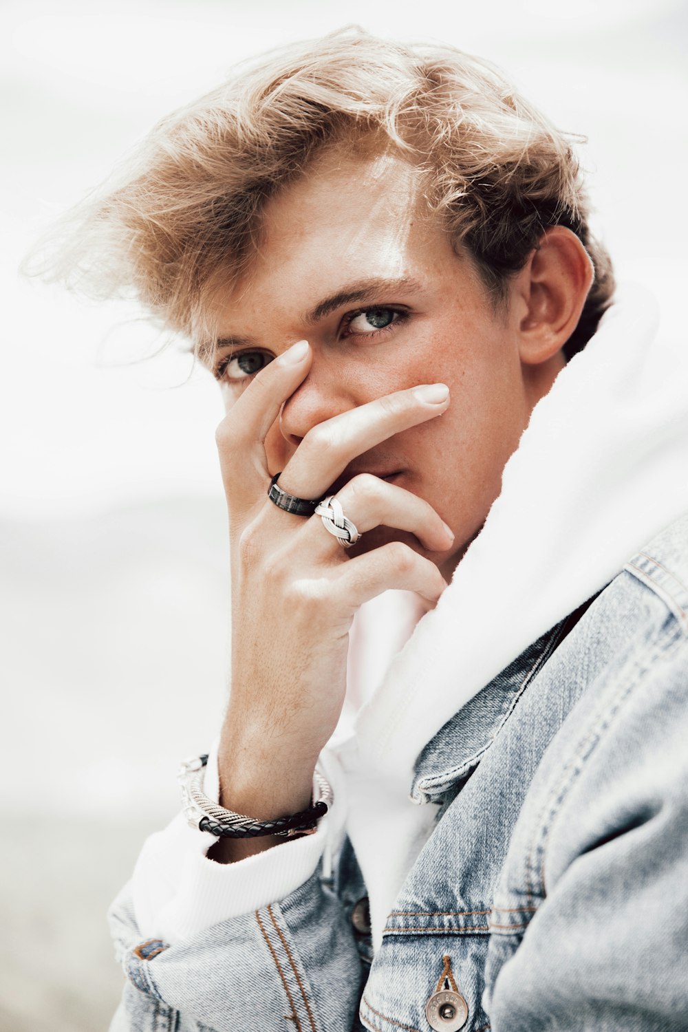 man in white long sleeve shirt and blue denim jeans