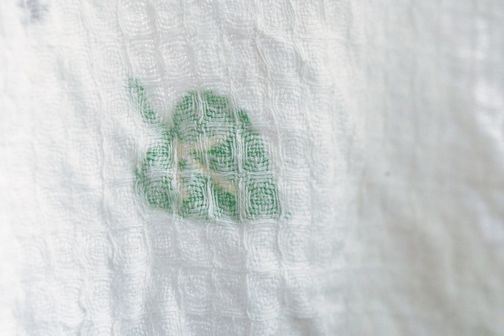 green and white frog print textile
