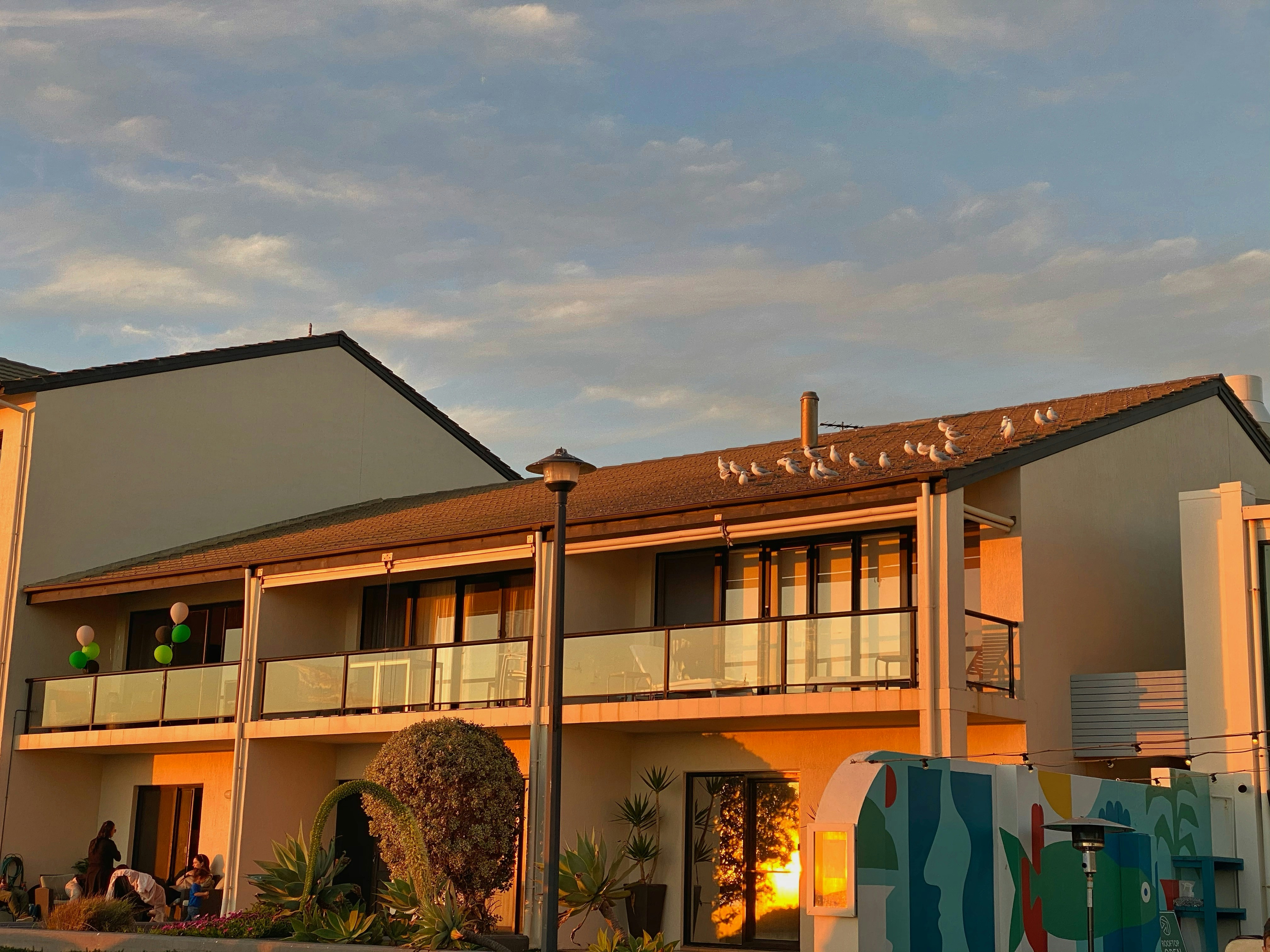 white and brown concrete building under white clouds during daytime