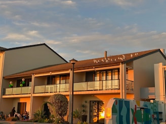 Evening shot of a building facade with newly installed pigeon nets glowing under warm lights