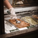 person in white gloves holding tray with food