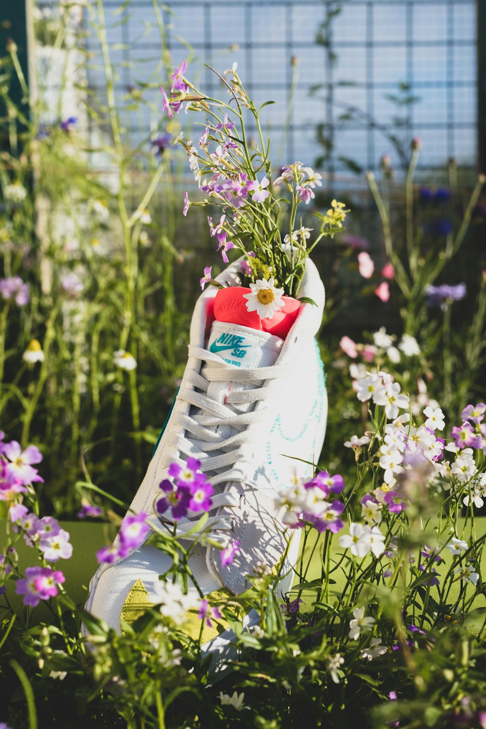 white and red floral ceramic vase on purple flower