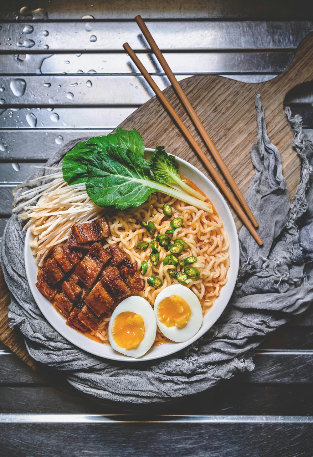 white ceramic bowl with brown wooden chopsticks