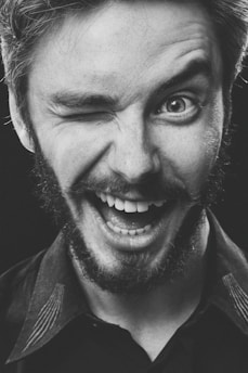 A close-up of a confident man smiling, showcasing a sense of empowerment and vitality.