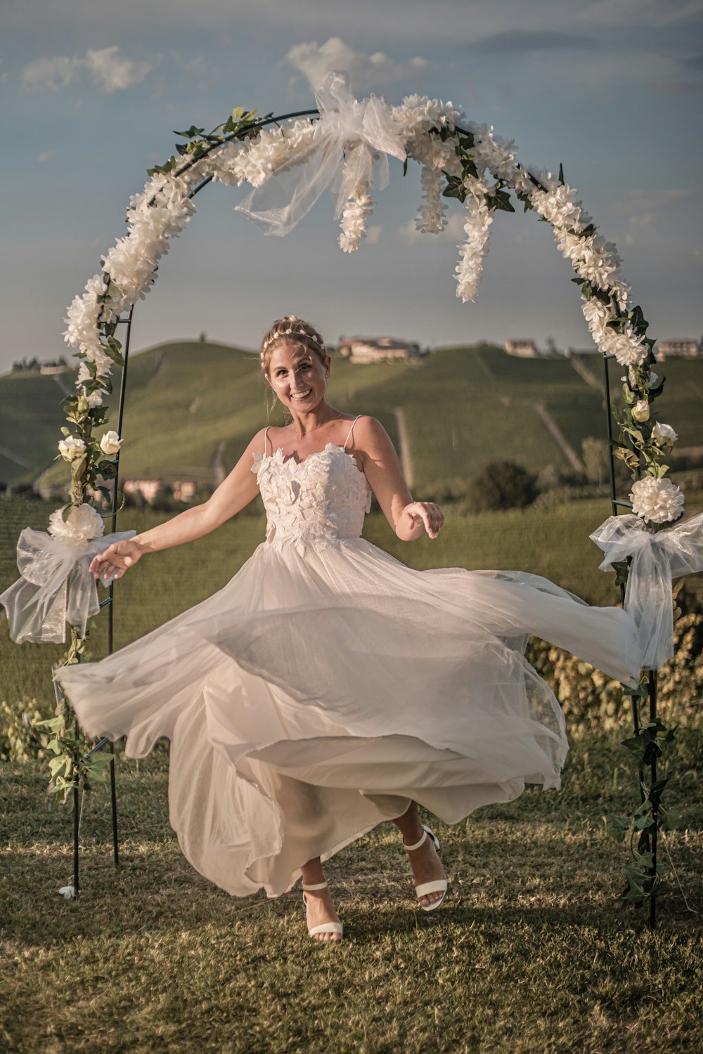 woman in white dress sitting on green grass field