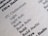 A close-up of a printed page displaying various font styles and weights including Light, Light Italic, Book, Book Italic, and Bold. The text is crisp and clear, showcasing different typography samples in black ink on a light gray or beige paper.