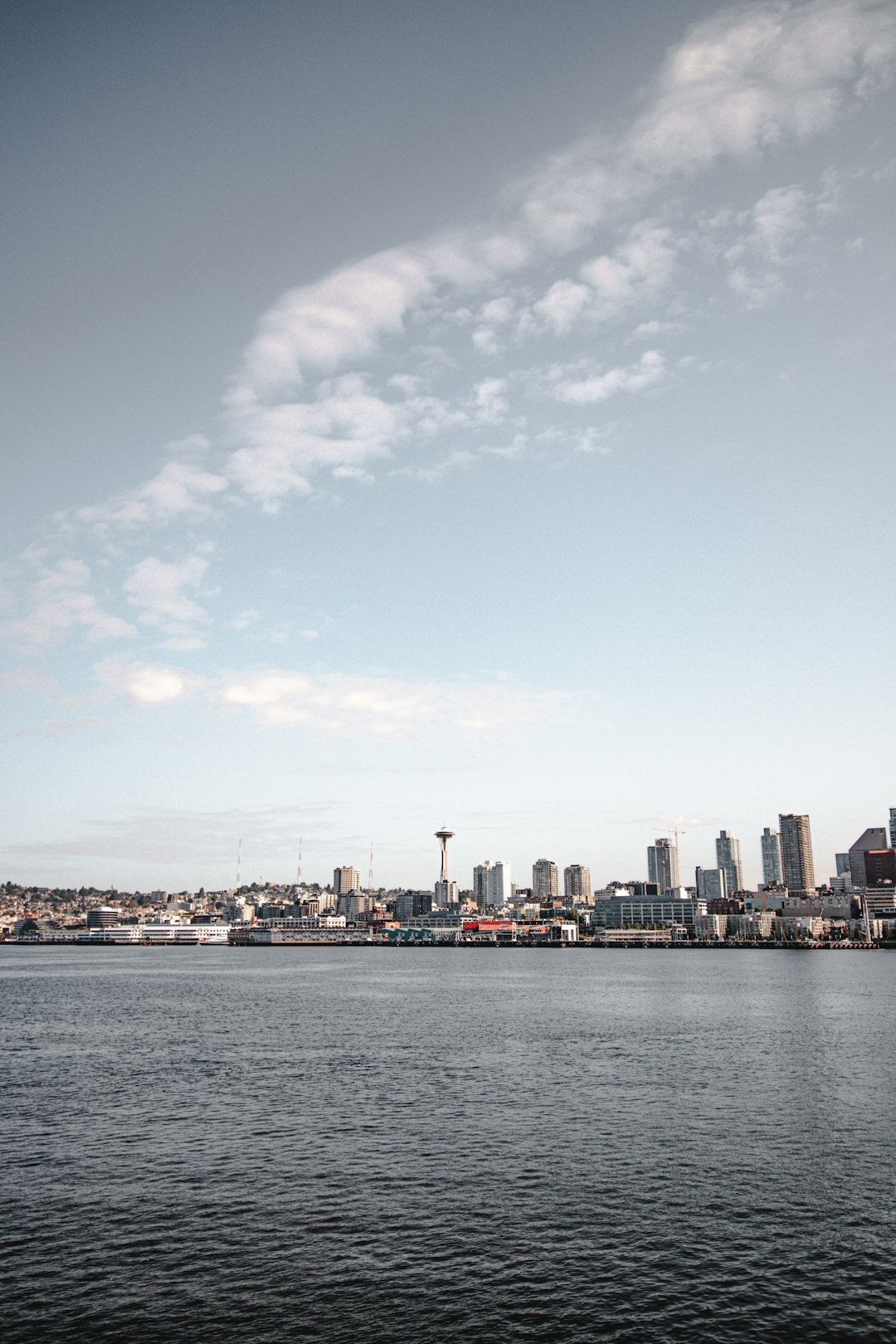 city skyline under blue sky and white clouds during daytime