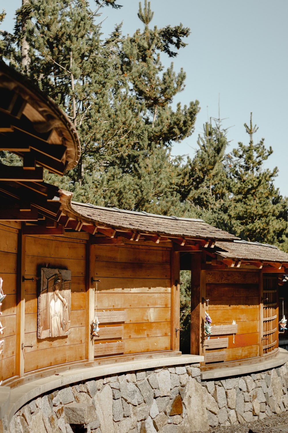 brown wooden house surrounded by green trees during daytime