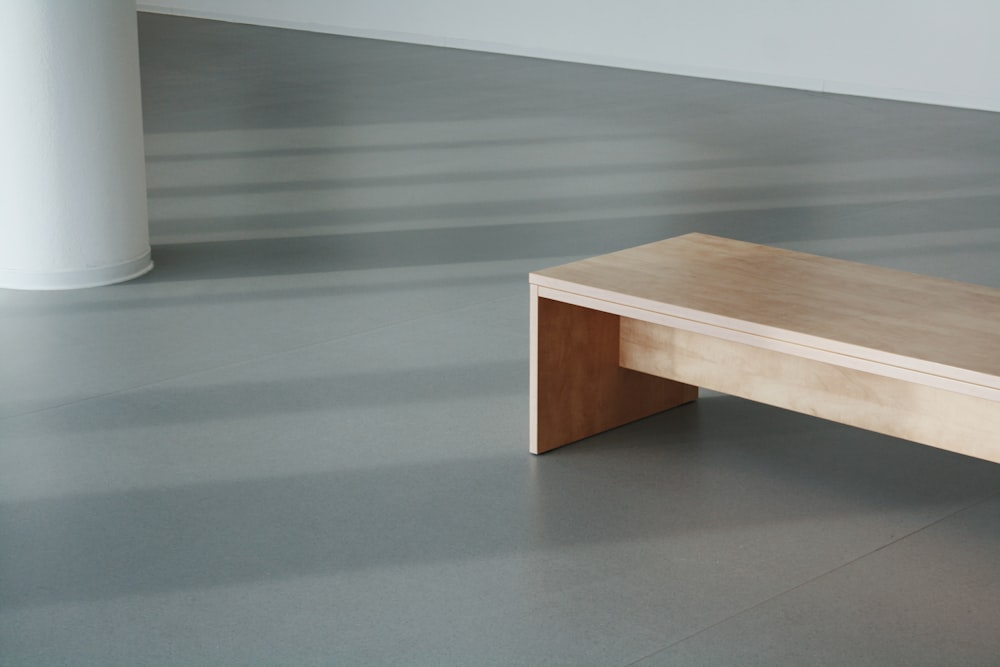 brown wooden table on gray floor