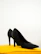 Pair of sleek women's urban shoes placed on a minimalistic white platform.