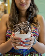 woman holding white disposable cup with ice cream