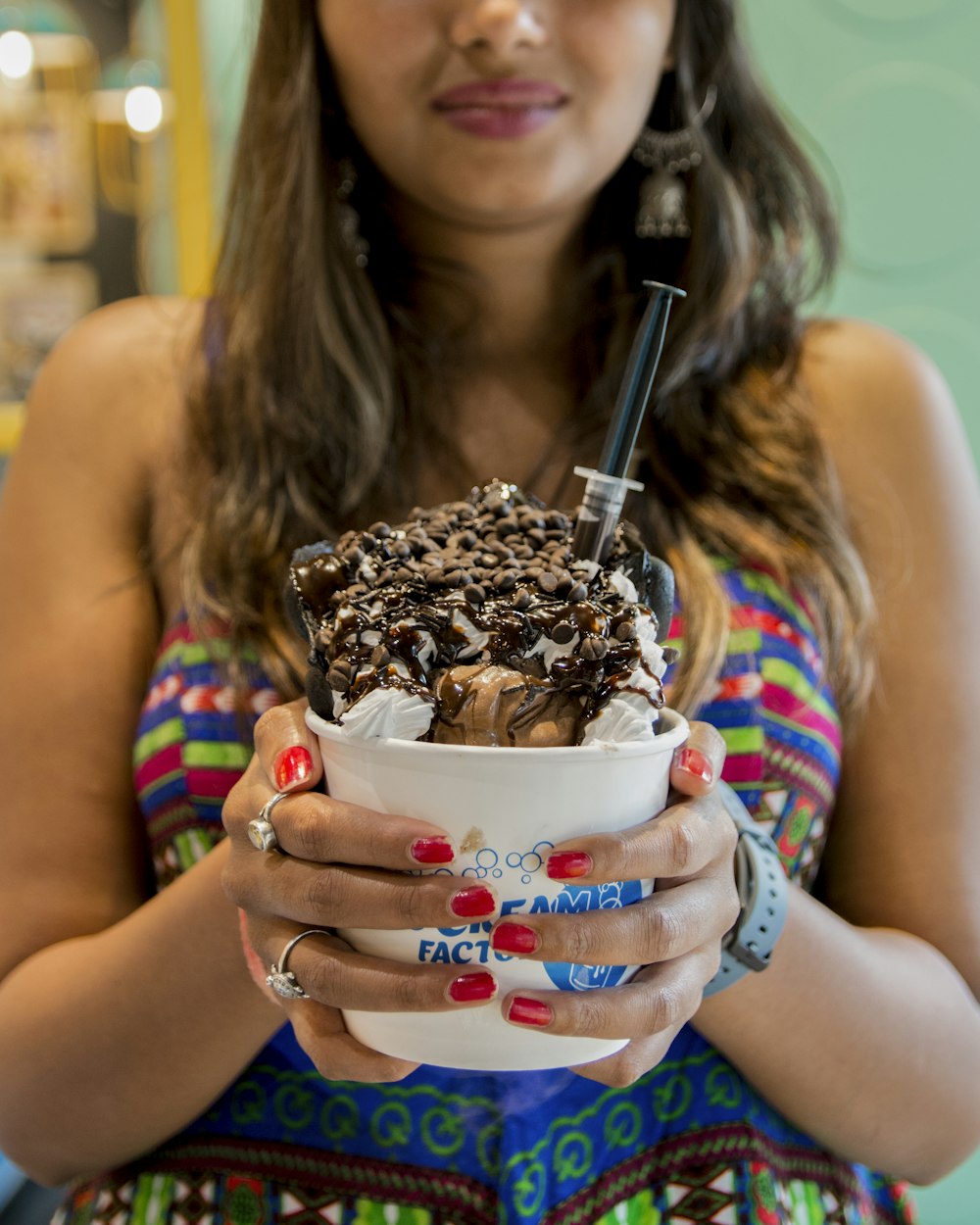 woman holding white disposable cup with ice cream