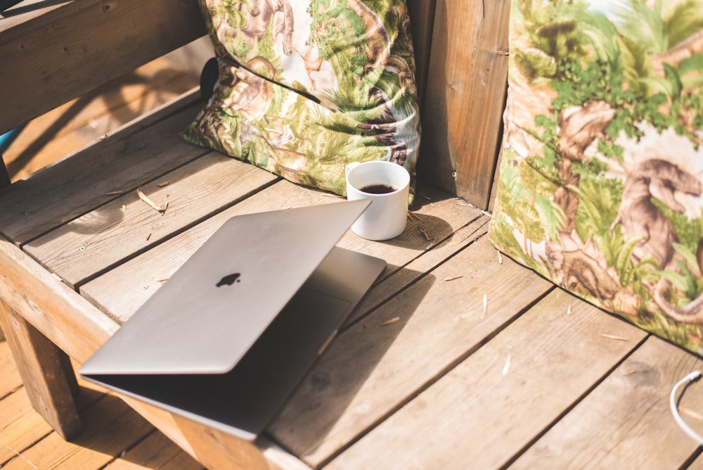 silver macbook on brown wooden table