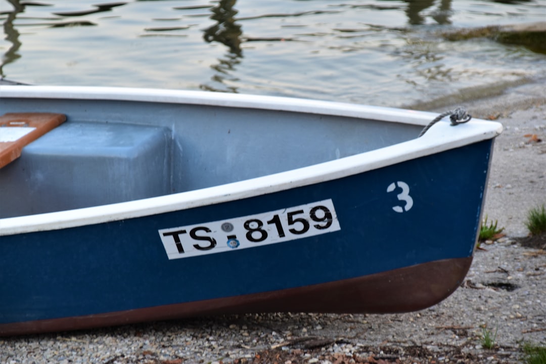 blue and white boat on water