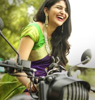 woman in yellow and green dress riding bicycle