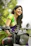 A happy young woman riding a new motorcycle she bought online.