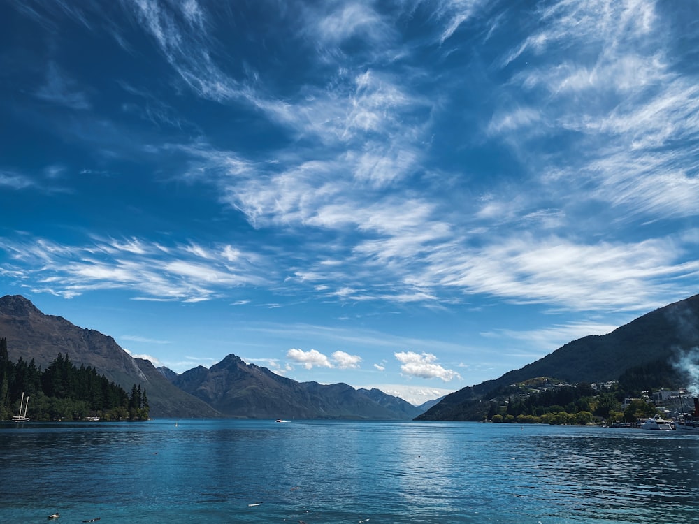 blue sea near mountain under blue sky during daytime