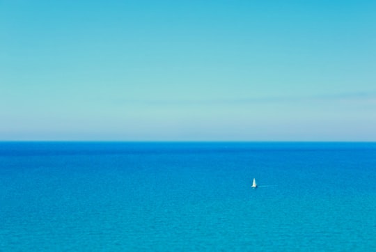 white boat on blue sea under blue sky during daytime in Licata Italy