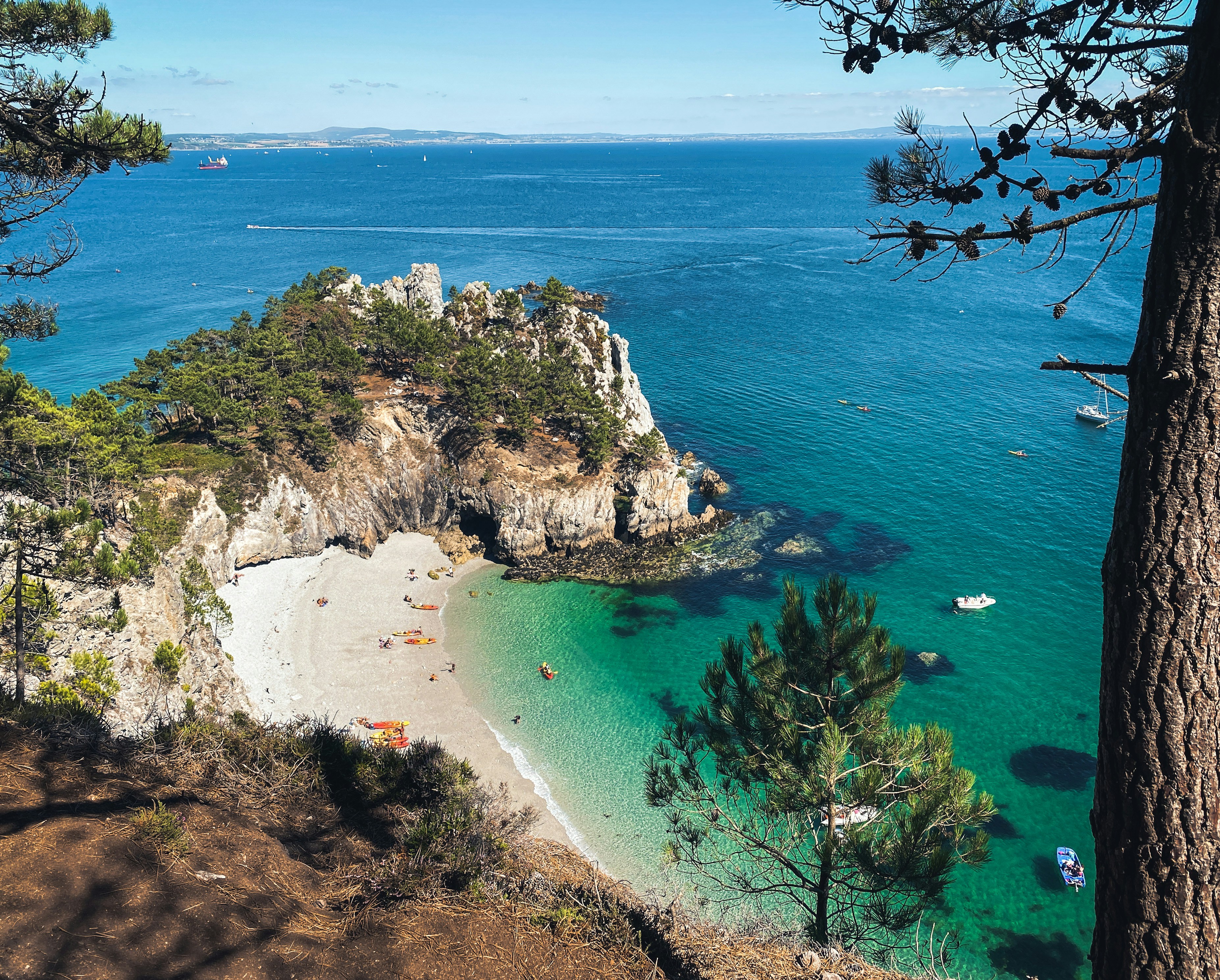 green and brown rock formation on blue sea water during daytime