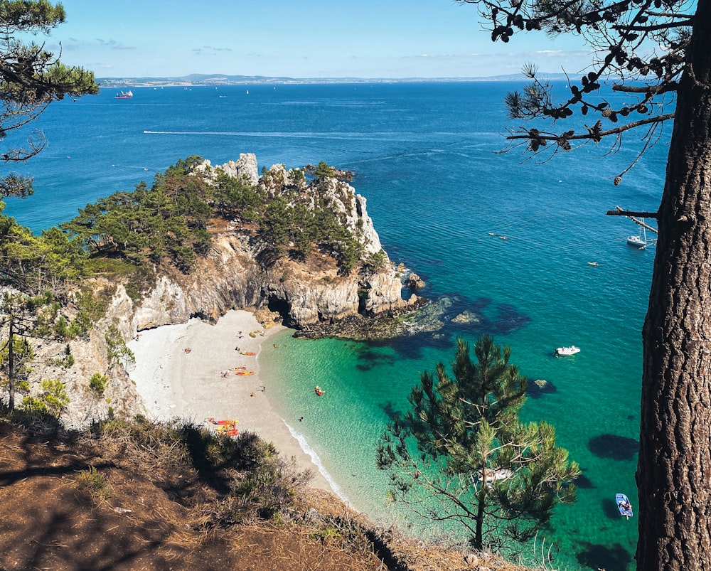 green and brown rock formation on blue sea water during daytime