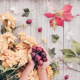 person holding red and yellow flowers