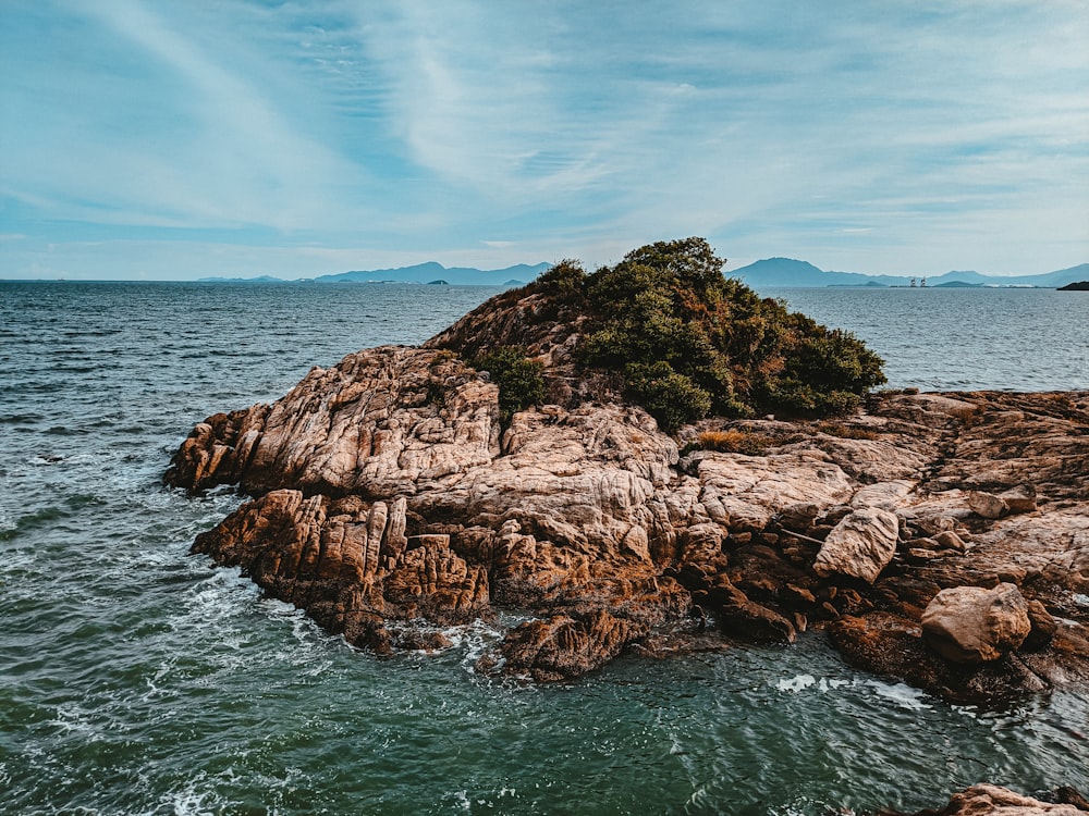 a rock outcropping in the middle of the ocean