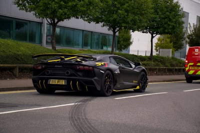 black porsche 911 parked on road during daytime