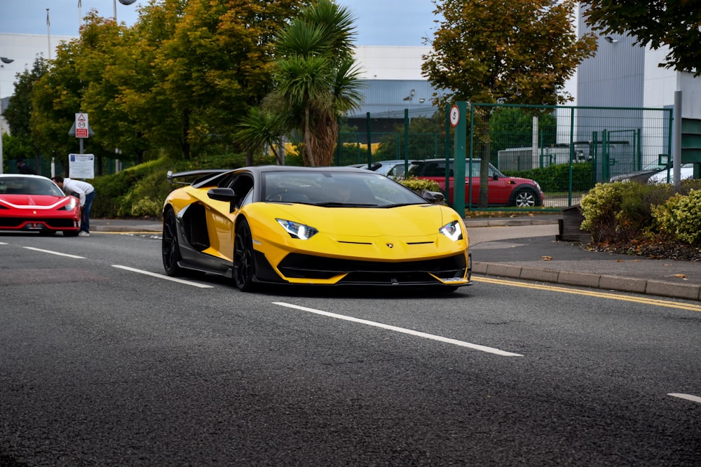 yellow lamborghini aventador on road during daytime