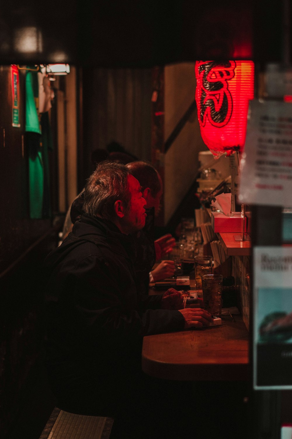 man in black jacket sitting on chair