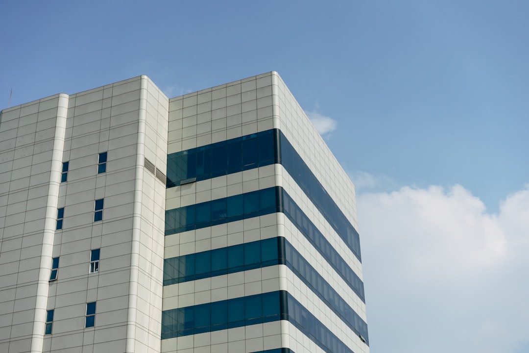 white and blue concrete building under blue sky during daytime