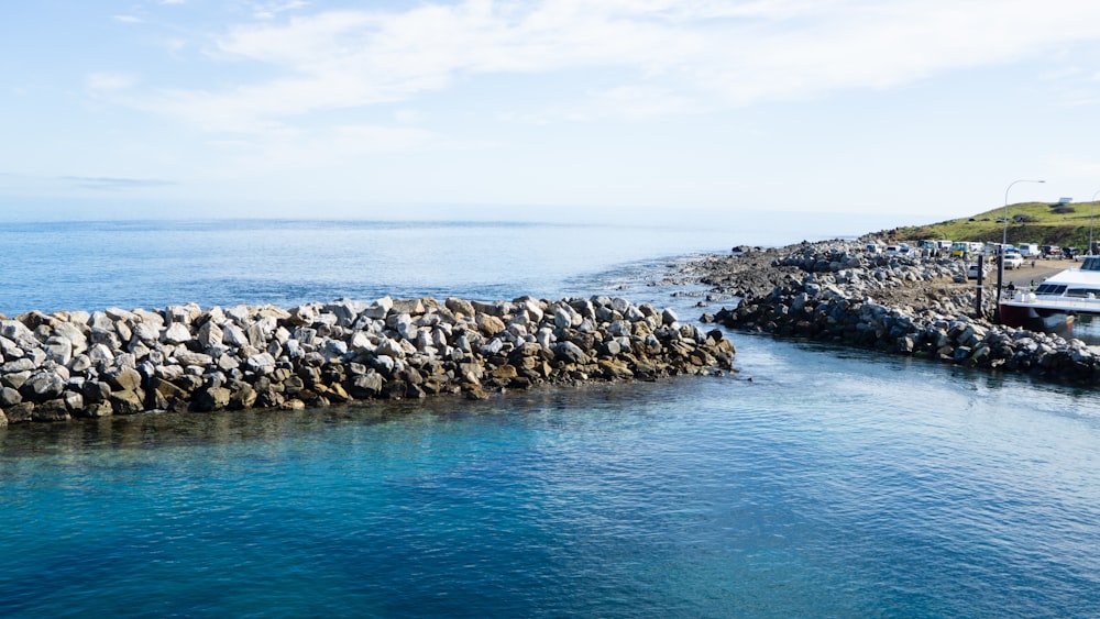 brown rocks on blue sea under blue sky during daytime