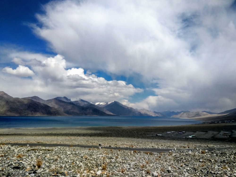 white clouds over the mountains and sea