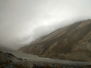 brown and green mountains under white clouds during daytime