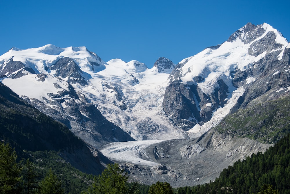 snow covered mountains under blue sky during daytime