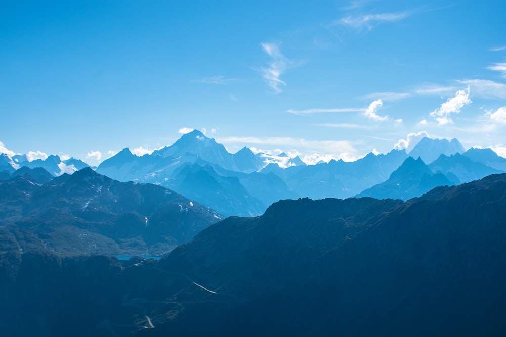 snow covered mountains under blue sky during daytime