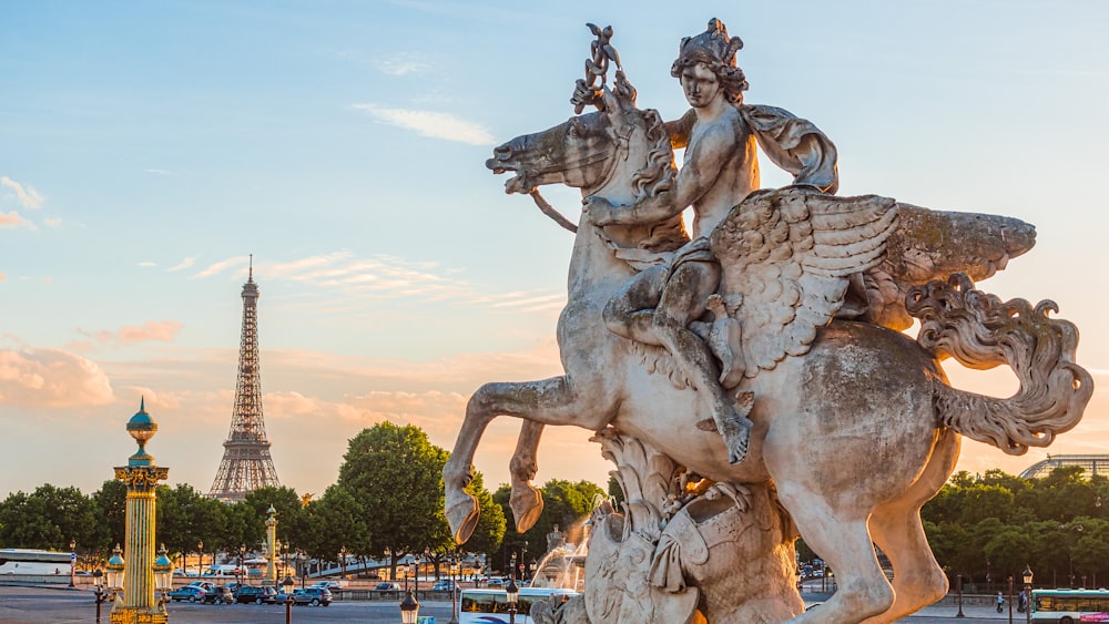 man riding horse statue during sunset