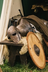 brown wooden round table with brown leather boots
